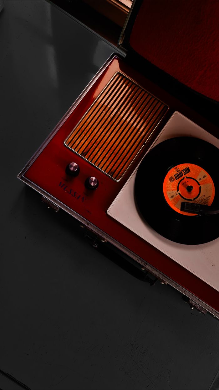 The Art of Drawing Readers In: Your attractive post title goes here Retro gramophone with vinyl record player showing an LP from above.
